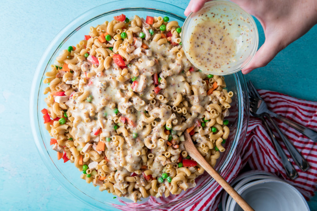 Putting Dressing on Allergy Friendly Pasta Salad